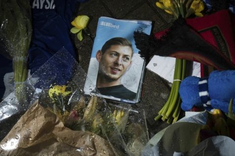 Tributes are placed outside the Cardiff City Stadium, Wales, for Emiliano Sala, Friday Feb. 8, 2019. Tributes are being paid across soccer to Argentine player Emiliano Sala, with the French league announcing a minute's applause before matches. French club Nantes says it will retire the No. 9 jersey worn by Sala before he was sold last month to Cardiff in the English Premier League. (Aaron Chown/PA via AP)