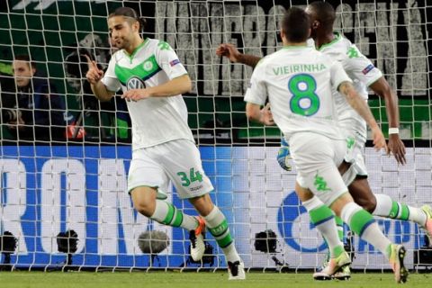 Wolfsburg's Ricardo Rodriguez, left, celebrates after scoring the opening goal from the penalty spot during the Champions League first leg quarter final soccer match between VfL Wolfsburg and Real Madrid in Wolfsburg, Germany, Wednesday, April 6, 2016. (AP Photo/Markus Schreiber)