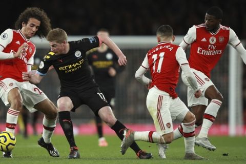 Manchester City's Kevin De Bruyne, second left, Arsenal's Matteo Guendouzi, left, Arsenal's Lucas Torreira, second right, and Arsenal's Ainsley Maitland-Niles during the English Premier League soccer match between Arsenal and Manchester City, at the Emirates Stadium in London, Sunday, Dec. 15, 2019. (AP Photo/Ian Walton)
