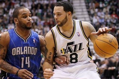 Utah Jazz point guard Deron Williams (8) attempts to get past Orlando Magic point guard Jameer Nelson (14) during the second half of an NBA basketball game in Salt Lake City, Friday Dec. 10, 2010. Williams scored 32 points in Utah's 117-105 win. (AP Photo/Colin E Braley)
