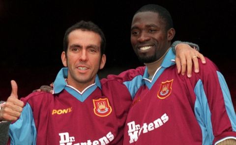 West Ham United's new signings Paolo Di Canio left, gives a thumbs up with his new team mate Marc-Vivien Foe as they pose for the cameras at West Ham's soccer ground in east London, Wednesday, Jan. 27, 1999. Italian Di Canio cost 1.7 million pounds ($2.8 million) from English club Sheffield Wednesday and Cameroon international Foe 4 million ($6.6 million) from French club Lens. Di Canio was recently banned for 11 games for pushing referee Paul Alcock during a game. (AP Photo/Alastair Grant)
