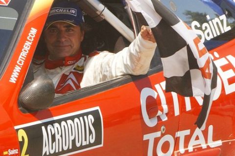 Spain's Carlos Sainz in his Citroen Xsara holds the chequered flag after finishing  the Acropolis Rally, in the city of Lamia, central Greece, on Sunday, June 26, 2005. Sainz took the third place at the last race of his career. (AP Photo/Thanassis Stavrakis) 