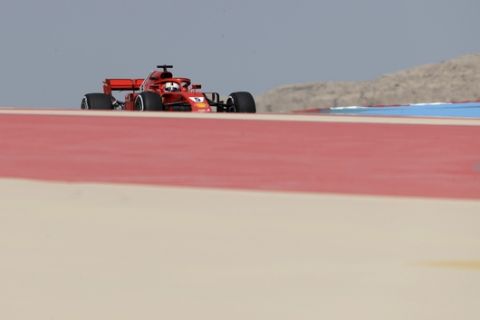 Ferrari driver Sebastian Vettel of Germany steers his carduring the first free practice at the Formula One Bahrain International Circuit in Sakhir, Bahrain, Friday, April 6, 2018. The Bahrain Formula One Grand Prix will take place here on Sunday. (AP Photo/Luca Bruno)