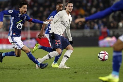 PSG's Adrien Rabiot, center, challenges the ball with Strasbourg's Jonas Martin during the League One soccer match between Strasbourg and Paris Saint Germain at the Stade de la Meinau stadium in Strasbourg, eastern France, Wednesday Dec.5, 2018. (AP Photo/Jean-Francois Badias)