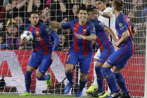 Barcelona's Neymar, left, and his teammates Luis Suarez and Ivan Rakitic celebrate after PSG's Layvin Kurzawa scored an own goal during the Champions League round of 16, second leg soccer match between FC Barcelona and Paris Saint Germain at the Camp Nou stadium in Barcelona, Spain, Wednesday March 8, 2017. (AP Photo/Emilio Morenatti)