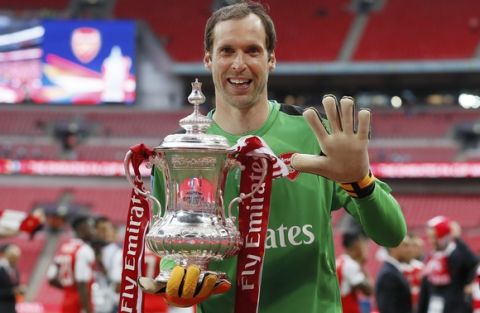 Arsenal goalkeeper Petr Cech poses with the trophy after winning the English FA Cup final soccer match between Arsenal and Chelsea at Wembley stadium in London, Saturday, May 27, 2017. Arsenal won 2-1. (AP Photo/Kirsty Wigglesworth)