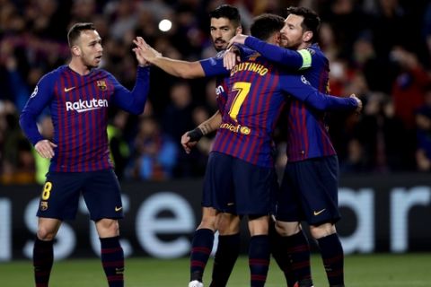 Barcelona forward Lionel Messi, right, celebrates with his teammates after scoring his side's opening goal from a penalty spot during the Champions League round of 16, 2nd leg, soccer match between FC Barcelona and Olympique Lyon at the Camp Nou stadium in Barcelona, Spain, Wednesday, March 13, 2019. (AP Photo/Manu Fernandez)