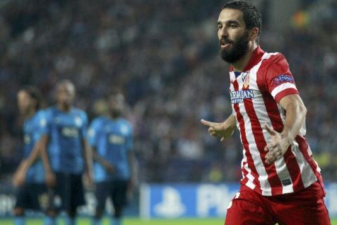 Atletico Madrid's Arda Turan celebrates after scoring a goal against Porto during their Champions League soccer match at Dragao stadium in Oporto, northern Portugal, October 1, 2013.      REUTERS/Jose Manuel Ribeiro (PORTUGAL  - Tags: SPORT SOCCER)  