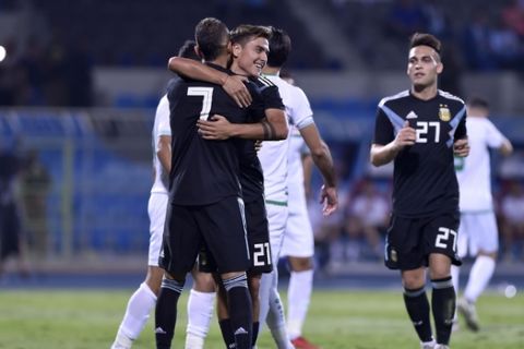 Argentina's Roberto Pereyra, left, celebrates scoring his side's second goal with his teammates Argentina's Paulo Dybala, center, and Argentina's Lautaro Martinez during a friendly soccer match between Argentina and Iraq at Prince Faisal bin Fahd stadium in Riyadh, Saudi Arabia, Thursday, Oct. 11, 2018. (AP Photo)