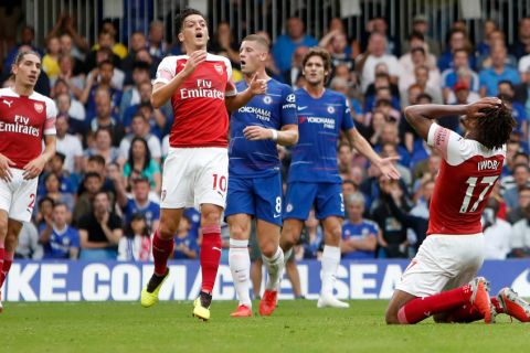 Arsenal's Alex Iwobi, right, reacts after missing a chance to score during the English Premier League soccer match between Chelsea and Arsenal at Stamford bridge stadium in London, Saturday, Aug. 18, 2018. (AP Photo/Alastair Grant)