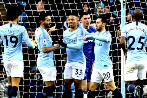 Manchester City's Gabriel Jesus, center, celebrates with teammates after scoring his sides first goal during the English Premier League soccer match between Manchester City and Everton at Etihad stadium in Manchester, England, Saturday, Dec. 15, 2018. (AP Photo/Rui Vieira)