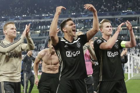 Ajax' players celebrate at the end of the Champions League, quarterfinal, second leg soccer match between Juventus and Ajax, at the Allianz stadium in Turin, Italy, Tuesday, April 16, 2019. Ajax won 2-1 and advances to the semifinal on a 3-2 aggregate. (AP Photo/Luca Bruno)