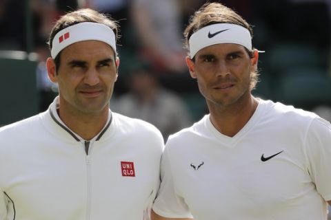 Spain's Rafael Nadal and Switzerland's Roger Federer, right, pose a men's singles semifinal match on day eleven of the Wimbledon Tennis Championships in London, Friday, July 12, 2019. (AP Photo/Ben Curtis)
