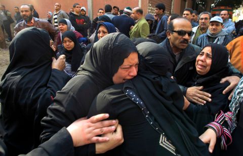 Egyptian women mourn at a morgue in Cairo on February 2, 2012, after 74 people were killed on February 1 in an eruption of violence at a football match in the northern city of Port Said between home team Al-Masri and Cairo's Al-Ahly. Egypt began three days of official mourning as anger grew against the military rulers for failing to ensure security.
AFP PHOTO/MAHMUD HAMS (Photo credit should read MAHMUD HAMS/AFP/Getty Images)