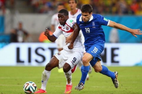RECIFE, BRAZIL - JUNE 29:  Joel Campbell of Costa Rica and Sokratis Papastathopoulos of Greece compete for the ball during the 2014 FIFA World Cup Brazil Round of 16 match between Costa Rica and Greece at Arena Pernambuco on June 29, 2014 in Recife, Brazil.  (Photo by Paul Gilham/Getty Images)