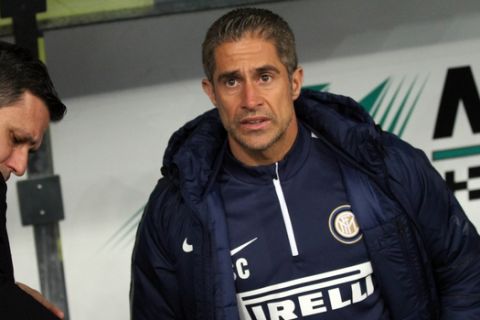 Inter Milan's assistant coach Sylvinho sits on the bench prior to a Serie A soccer match against Chievo at Bentegodi stadium in Verona, Italy, Monday, Dec. 15, 2014. (AP Photo/Felice Calabro')