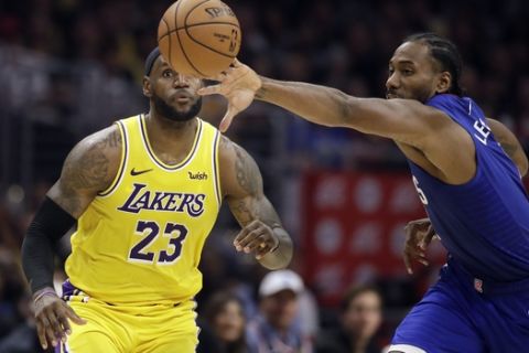 Los Angeles Clippers' Kawhi Leonard, right, steals the ball from Los Angeles Lakers' LeBron James (23) during the second half of an NBA basketball game Tuesday, Oct. 22, 2019, in Los Angeles. (AP Photo/Marcio Jose Sanchez)