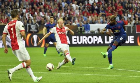 United's Paul Pogba, right, scores the opening goal during the soccer Europa League final between Ajax Amsterdam and Manchester United at the Friends Arena in Stockholm, Sweden, Wednesday, May 24, 2017. (AP Photo/Martin Meissner)