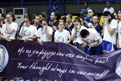 Συγκινημένες οι αθλήτριες της Εθνικής κρατούν το πανό για τη Βάσω Μπεσκάκη