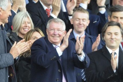 Former Manchester United manager Alex Ferguson, center, applauds as he takes his seat on the stands before the English Premier League soccer match between Manchester United and Wolverhampton Wanderers at Old Trafford stadium in Manchester, England, Saturday, Sept. 22, 2018. (AP Photo/Rui Vieira)