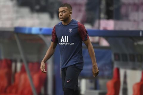 PSG's Kylian Mbappe arrives for a training session at the Luz stadium in Lisbon, Tuesday Aug. 11, 2020. PSG will play Atalanta in a Champions League quarterfinals soccer match on Wednesday. (David Ramos/Pool via AP)