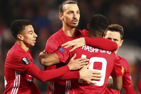 Manchester United's Zlatan Ibrahimovic, center, celebrates with teammates after scoring during the Europa League round of 32 first leg soccer match between Manchester United and St.-Etienne at the Old Trafford stadium in Manchester, England, Thursday, Feb. 16, 2017 . (AP Photo/Dave Thompson)