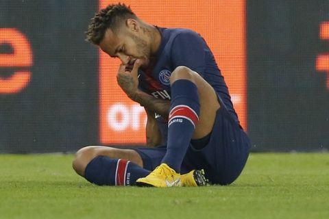 PSG's Neymar reacts sitting on the pitch during their League One soccer match between Paris Saint-Germain and Caen at Parc des Princes stadium in Paris, Sunday, Aug. 12, 2018. (AP Photo/Michel Euler)