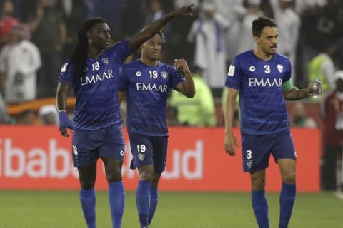 Al Hilal's Bafetimbi Gomis, left, celebrates after scoring his side's opening goal during the Club World Cup soccer match between Al Hilal FC and ES Tunis at Jassim Bin Hamad Stadium in Doha, Qatar, Saturday, Dec. 14, 2019. (AP Photo/Hassan Ammar)