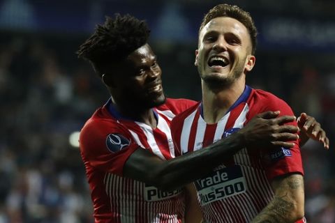 Atletico's Saul Niguez, right, celebrates after scoring his side's third goal during the UEFA Super Cup final soccer match between Real Madrid and Atletico Madrid at the Lillekula stadium in Tallinn, Estonia, Wednesday, Aug. 15, 2018. (AP Photo/Mindaugas Kulbis)