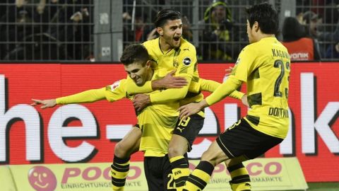 Dortmund's Christian Pulisic, left, is celebrated after he scored his side's second goal during the German Bundesliga soccer match between Borussia Dortmund and TSG Hoffenheim in Dortmund, Germany, Saturday, Dec. 16, 2017. Dortmund defeated Hoffenheim with 2-1. (AP Photo/Martin Meissner)