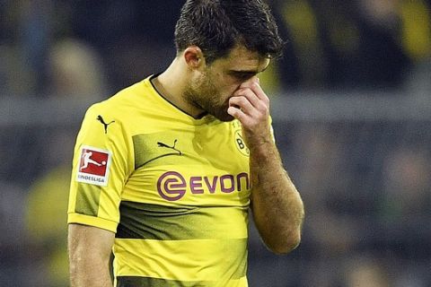 Dortmund's Sokratis leaves the pitch after a red card during the German Bundesliga soccer match between Borussia Dortmund and RB Leipzig in Dortmund, Germany, Saturday, Oct. 14, 2017. (AP Photo/Martin Meissner)
