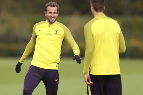 Tottenham Hotspur's striker Harry Kane, left, attends a training session at Enfield Training Centre, London, Tuesday, Oct. 31, 2017. Kane is back in training and could face Real Madrid in the Champions League on Wednesday. (Adam Davy/PA via AP)