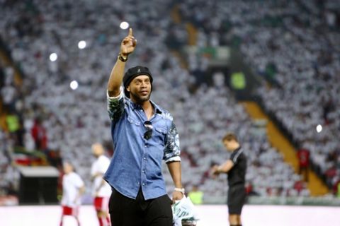 In this photo taken on Sunday, July 16, 2017, Brazilian soccer star and former FC Barcelona player Ronaldinho greets fans at the stadium in Grozny, Russia. Ronaldinho had visited Grozny, Russia, to attend the relaunch of the city's football club. (AP Photo/Musa Sadulayev)
