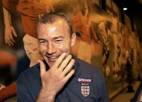 England's soccer captain Alan Shearer walks past pictures of the English team after a news conference on the EURO 2000 championship in the small town Spa in the south east of Belgium Thursday, June 15, 2000.  (AP Photo/Adam Butler)