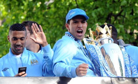 MANCHESTER, ENGLAND - MAY 14:  Sergio Aguero of Manchester City celebrates with the Barclays Premier League trophy next to team-mate Gael Clichy in front of Manchester Town Hall during the victory parade around the streets of Manchester on May 14, 2012 in Manchester, United Kingdom.  (Photo by Chris Brunskill/Getty Images)