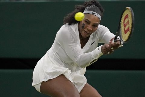 Serena Williams of the US returns to France's Harmony Tan in a first round women's singles match on day two of the Wimbledon tennis championships in London, Tuesday, June 28, 2022. (AP Photo/Alberto Pezzali)