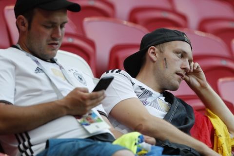Germany fans sit dejected in the stands after their team lose the group F match between South Korea and Germany, at the 2018 soccer World Cup in the Kazan Arena in Kazan, Russia, Wednesday, June 27, 2018. South Korea won the match 2-0. (AP Photo/Frank Augstein)