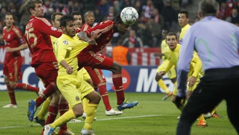 Bayern's David Alaba of Austria, right, and Villarreal's Joan Oriol challenge for the ball during their Champions League Group A soccer match between FC Bayern Munich and Villarreal in Munich, southern Germany, on Tuesday, Nov. 22, 2011. (AP Photo/Matthias Schrader)