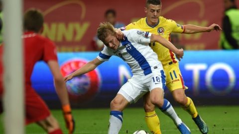 Gabriel Torje (R) of Romania vies for the ball with Jere Uronen (C) of Finland during the Euro 2016 Group F qualifying football match between Romania and Finland at the National Arena in Bucharest, Romania on October 8, 2015. AFP PHOTO / DANIEL MIHAILESCU        (Photo credit should read DANIEL MIHAILESCU/AFP/Getty Images)