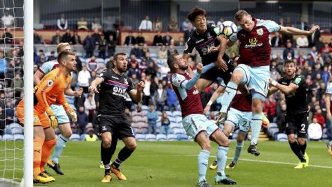Burnley's Chris Wood, top right, and Crystal Palace's Lee Chung-yong battle for the ball during the English Premier League soccer match at Turf Moor, Burnley, England, Sunday Sept. 10, 2017. (Martin Rickett/PA via AP)