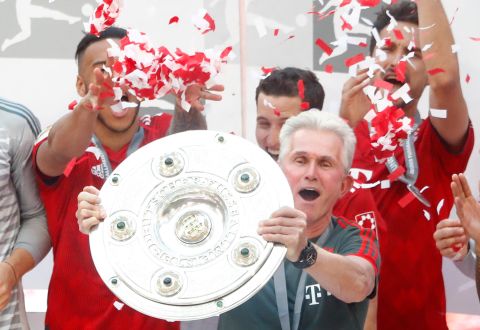 Bayern's head coach Jupp Heynckes lifts the trophy after the German Soccer Bundesliga match between FC Bayern Munich and VfB Stuttgart in Munich, Germany, Saturday, May 12, 2018. (AP Photo/Matthias Schrader)