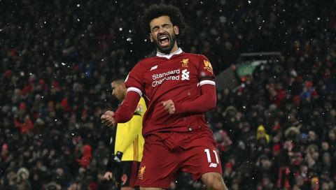 Liverpool's Mohamed Salah celebrates scoring his hat-trick during the English Premier League soccer match between Liverpool and Watford at Anfield, Liverpool, England, Saturday, March 17, 2018. (Anthony Devlin/PA via AP)