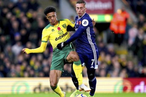 Norwich City's Jamal Lewis, left, and Watford's Gerard Deulofeu battle for the ball during the English Premier League soccer match at Carrow Road, Norwich, England, Friday Nov. 8, 2019. (John Walton/PA via AP)