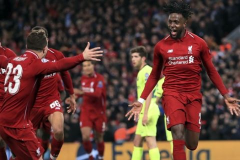 Liverpool's Divock Origi, right, celebrates scoring his side's fourth goal of the game during the Champions League Semi Final, second leg soccer match between Liverpool and Barcelona at Anfield, Liverpool, England, Tuesday, May 7, 2019. (Peter Byrne/PA via AP)