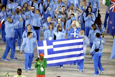 Athletes from Greece carry their flag into the closing ceremony in the Maracana stadium at the 2016 Summer Olympics in Rio de Janeiro, Brazil, Sunday, Aug. 21, 2016. (AP Photo/Charlie Riedel)