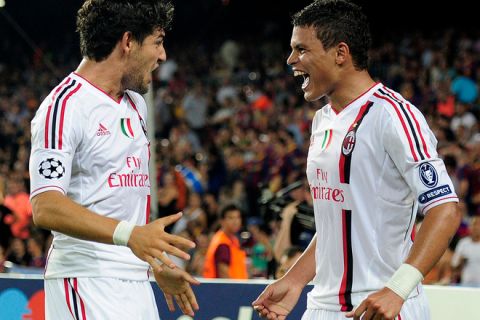 AC Milan's Brazilian defender Thiago Silva (R) celebrates with AC Milan's Brazilian forward Pato (L) after scoring during their Champions League football match Barcelona vs AC Milan on September 13, 2011 at the Camp Nou stadium in Barcelona. AFP PHOTO/ JOSEP LAGO (Photo credit should read JOSEP LAGO/AFP/Getty Images)