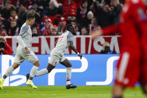 Liverpool midfielder Sadio Mane, right, celebrates after scoring his side's first goal during the Champions League round of 16 second leg soccer match between Bayern Munich and Liverpool in Munich, Germany, Wednesday, March 13, 2019. (AP Photo/Matthias Schrader)