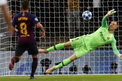 Barcelona midfielder Arthur, left, watch his goalkeeper Marc-Andre ter Stegen, right, making a save during the Champions League Group B soccer match between Tottenham Hotspur and Barcelona at Wembley Stadium in London, Wednesday, Oct. 3, 2018. (AP Photo/Frank Augstein)