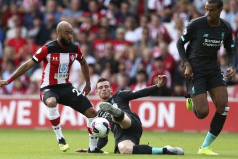 Southampton's Nathan Redmond, left and Liverpool's Andrew Robertson battle for the ball during the English Premier League soccer match between Southampton and Liverpool, at St Mary's, in Southampton, England, Saturday, Aug. 17, 2019. (Steven Paston/PA via AP)
