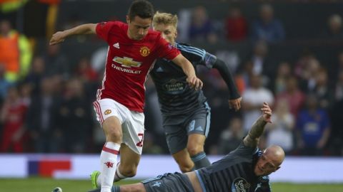 Manchester United's Ander Herrera, left takes the ball past Celta's John Guidetti during the Europa League semifinal second leg soccer match between Manchester United and Celta Vigo at Old Trafford in Manchester, England, Thursday, May 11, 2017. (AP Photo/Dave Thompson)